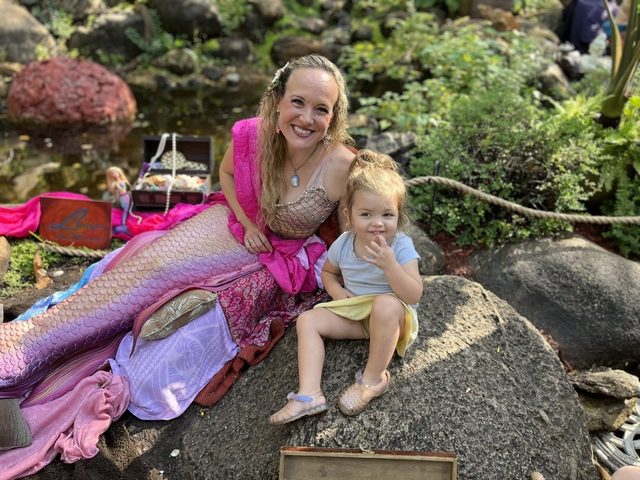 A child with a costumed performer at the Renaissance Festival in 2023